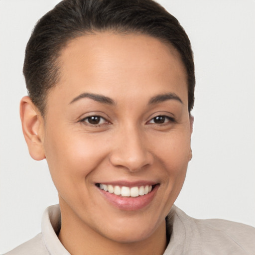 Joyful white young-adult female with short  brown hair and brown eyes