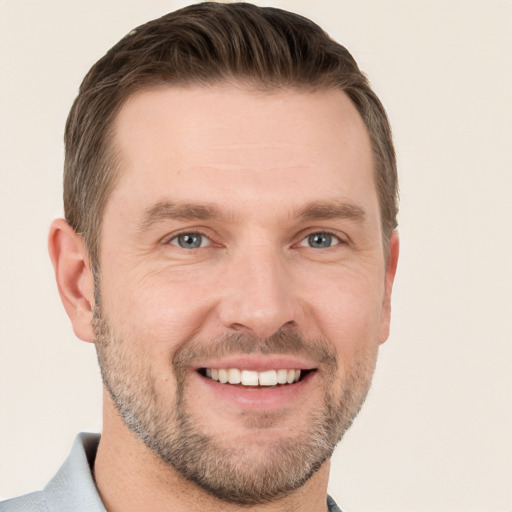 Joyful white adult male with short  brown hair and grey eyes