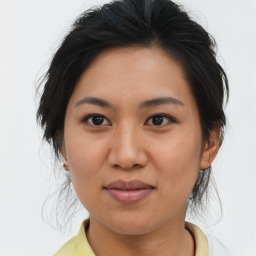 Joyful asian young-adult female with medium  brown hair and brown eyes