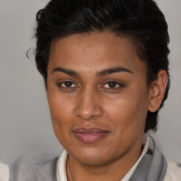 Joyful latino young-adult female with short  brown hair and brown eyes