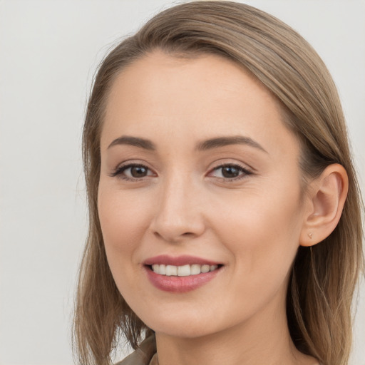 Joyful white young-adult female with long  brown hair and brown eyes