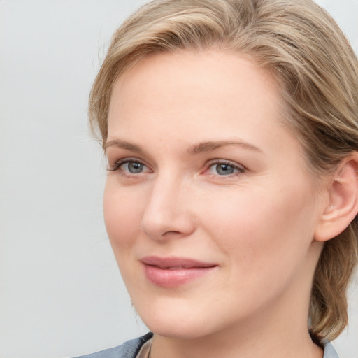 Joyful white young-adult female with medium  brown hair and blue eyes