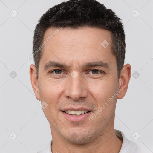 Joyful white adult male with short  brown hair and brown eyes