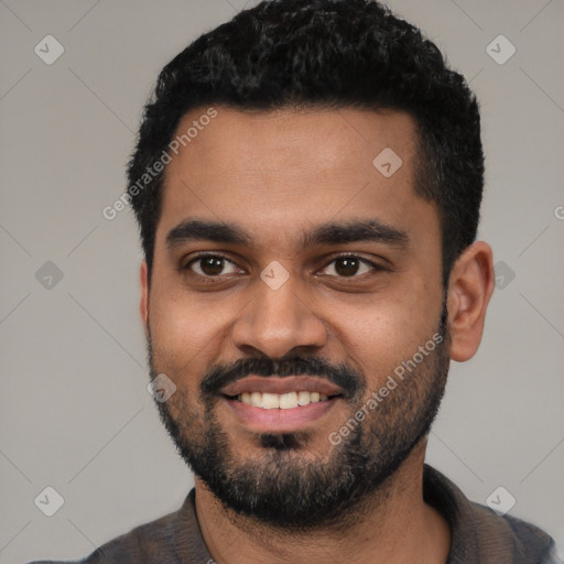 Joyful black young-adult male with short  black hair and brown eyes