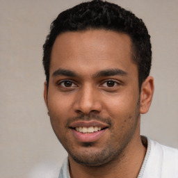 Joyful white young-adult male with short  black hair and brown eyes