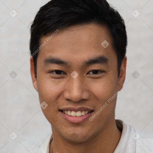 Joyful asian young-adult male with short  black hair and brown eyes