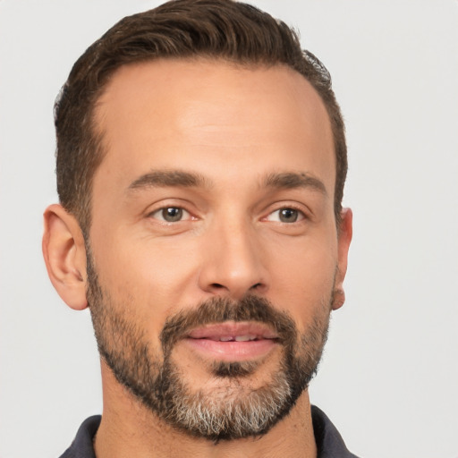 Joyful white adult male with short  brown hair and brown eyes