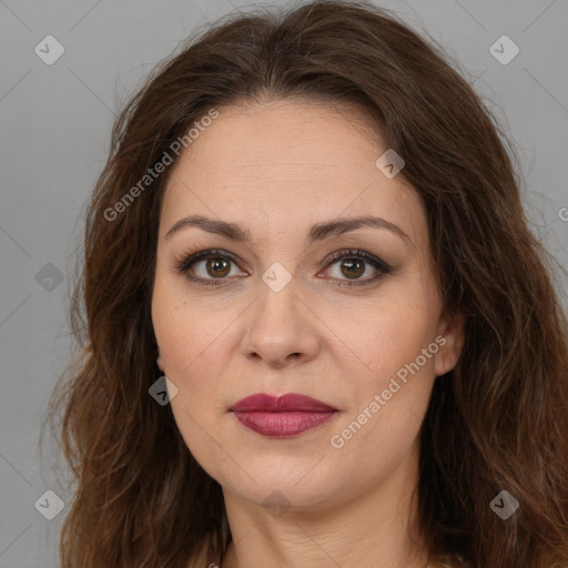 Joyful white adult female with long  brown hair and brown eyes