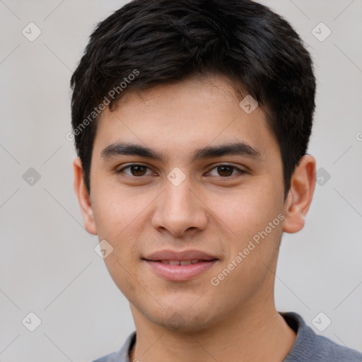 Joyful white young-adult male with short  black hair and brown eyes