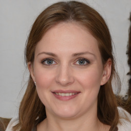 Joyful white young-adult female with medium  brown hair and blue eyes