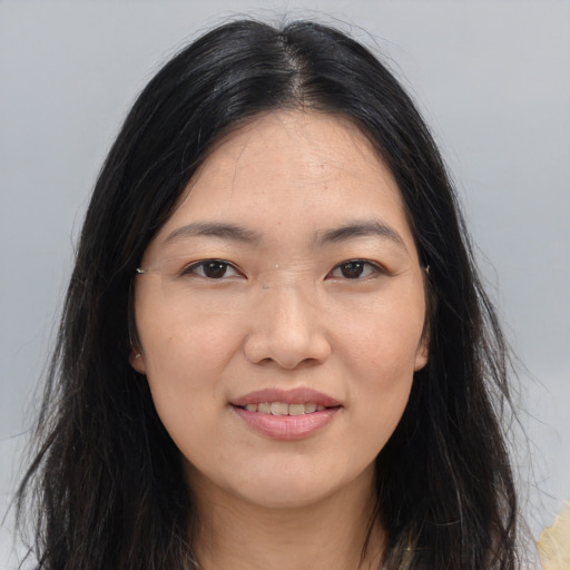 Joyful asian young-adult female with long  black hair and brown eyes