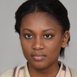 Neutral black young-adult female with medium  brown hair and brown eyes