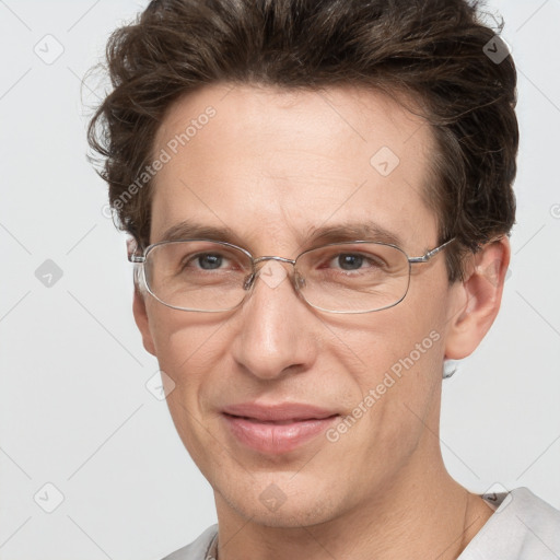 Joyful white adult male with short  brown hair and grey eyes