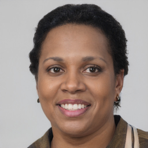 Joyful latino adult female with short  brown hair and brown eyes