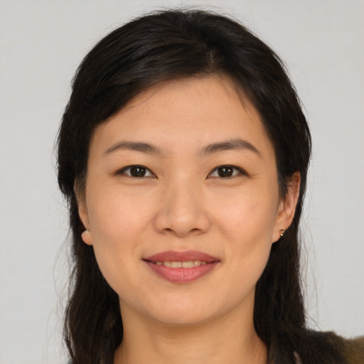Joyful asian young-adult female with long  brown hair and brown eyes