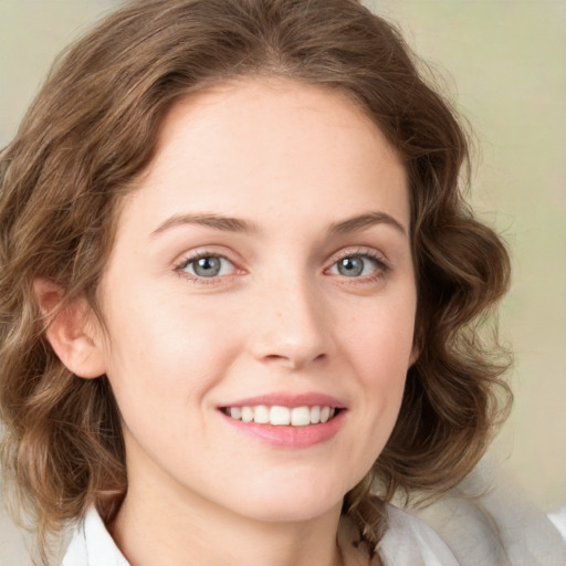 Joyful white young-adult female with medium  brown hair and green eyes