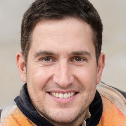 Joyful white adult male with short  brown hair and brown eyes