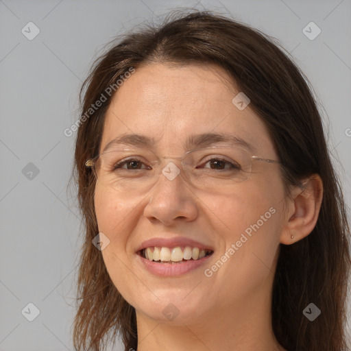 Joyful white adult female with long  brown hair and brown eyes