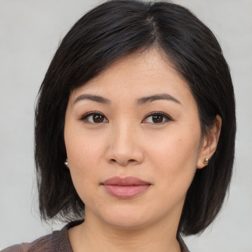 Joyful asian young-adult female with medium  black hair and brown eyes