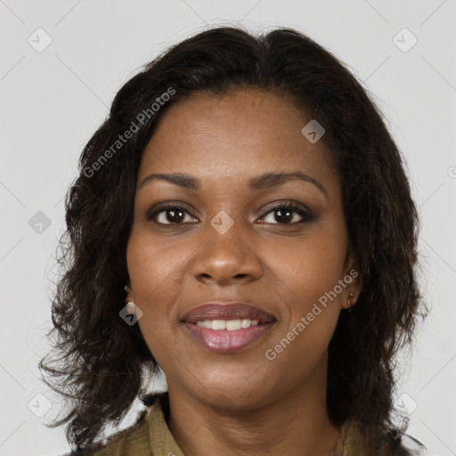 Joyful black young-adult female with long  brown hair and brown eyes