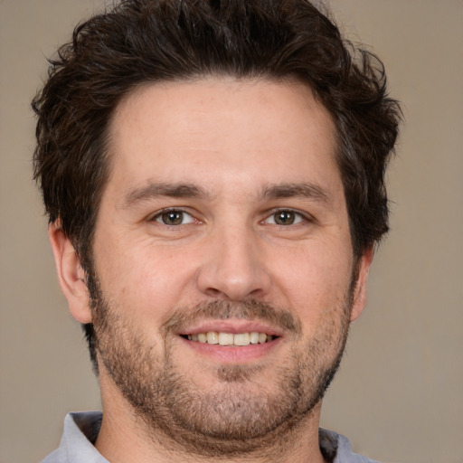 Joyful white adult male with short  brown hair and brown eyes