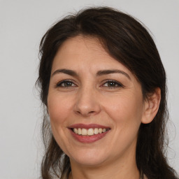 Joyful white adult female with medium  brown hair and brown eyes