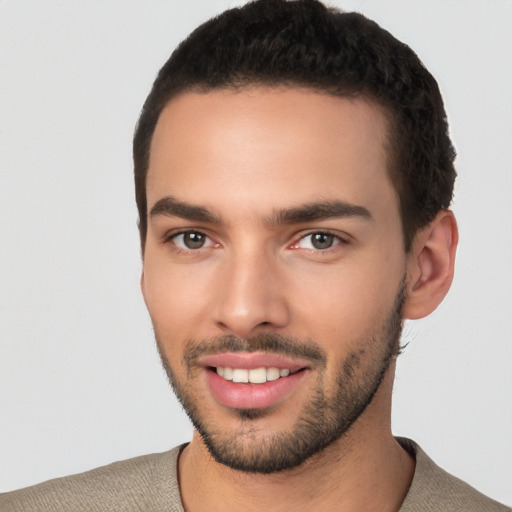 Joyful white young-adult male with short  black hair and brown eyes