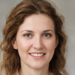 Joyful white young-adult female with long  brown hair and green eyes