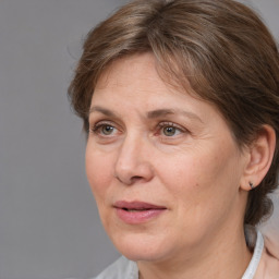 Joyful white adult female with medium  brown hair and grey eyes