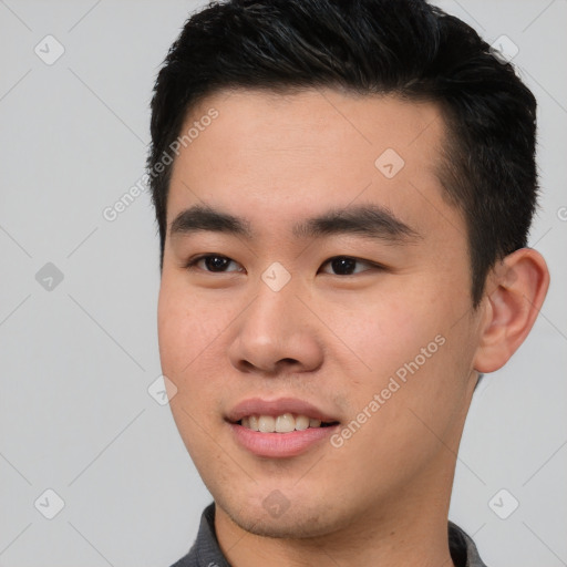 Joyful asian young-adult male with short  black hair and brown eyes