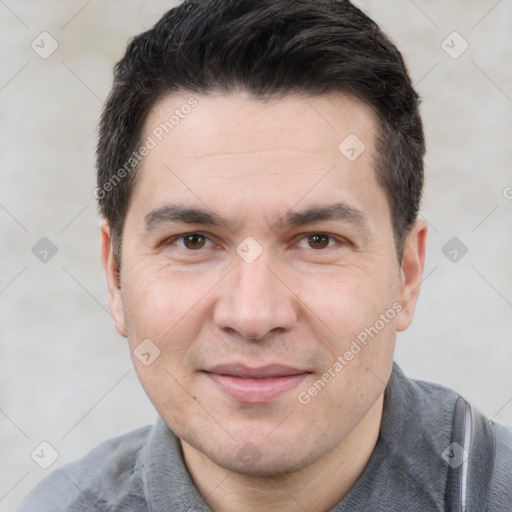 Joyful white adult male with short  black hair and brown eyes