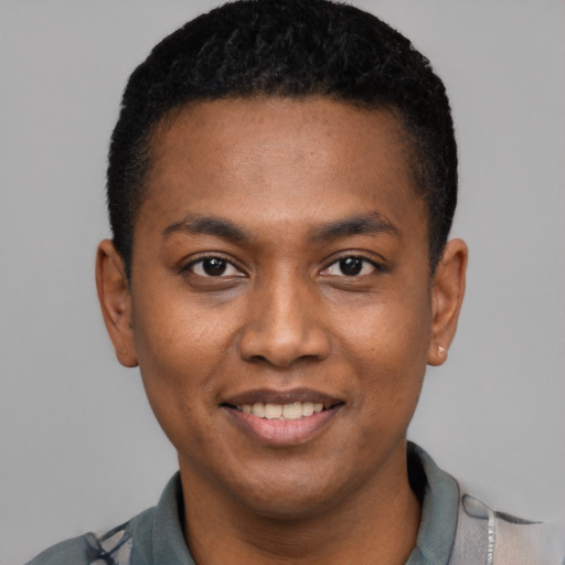 Joyful black young-adult male with short  black hair and brown eyes
