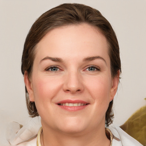 Joyful white young-adult female with medium  brown hair and grey eyes