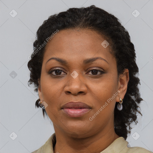 Joyful black adult female with medium  brown hair and brown eyes