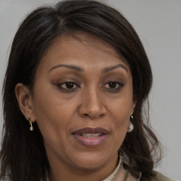 Joyful white adult female with long  brown hair and brown eyes