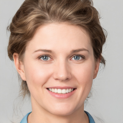 Joyful white young-adult female with medium  brown hair and blue eyes