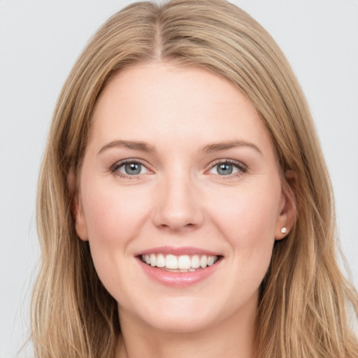 Joyful white young-adult female with long  brown hair and green eyes