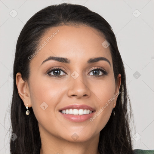 Joyful latino young-adult female with long  black hair and brown eyes