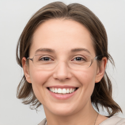 Joyful white young-adult female with medium  brown hair and grey eyes