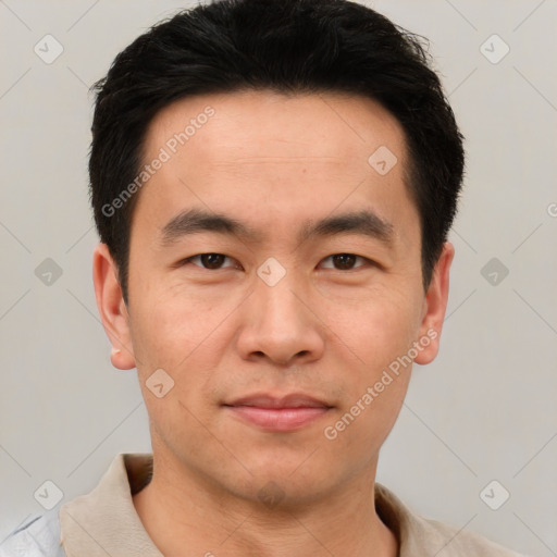 Joyful asian young-adult male with short  black hair and brown eyes