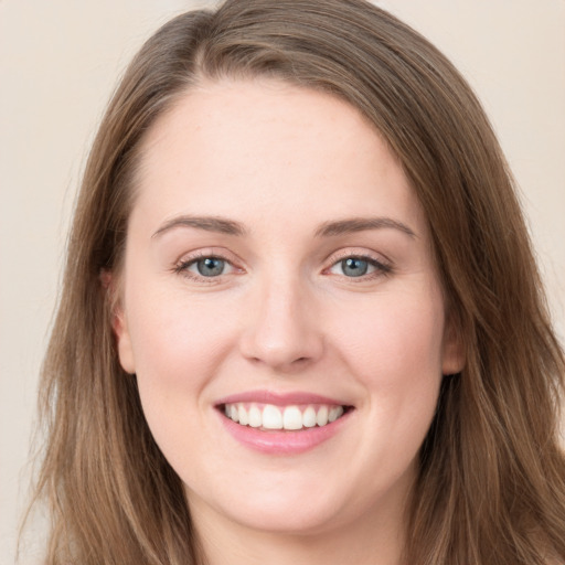 Joyful white young-adult female with long  brown hair and green eyes