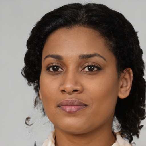 Joyful black young-adult female with medium  brown hair and brown eyes