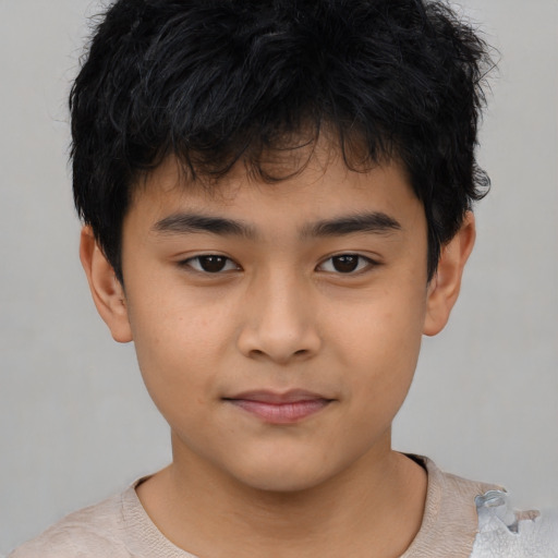 Joyful asian child male with short  brown hair and brown eyes