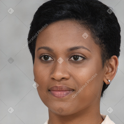 Joyful black young-adult female with short  black hair and brown eyes