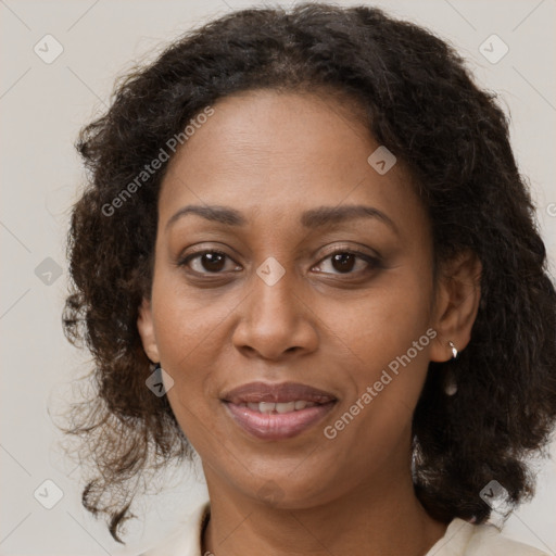 Joyful black adult female with medium  brown hair and brown eyes