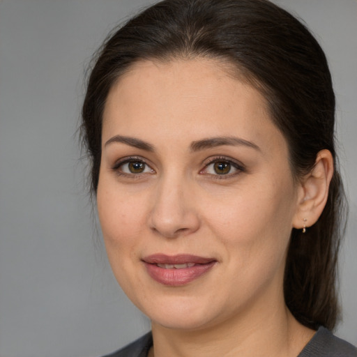 Joyful white young-adult female with medium  brown hair and brown eyes