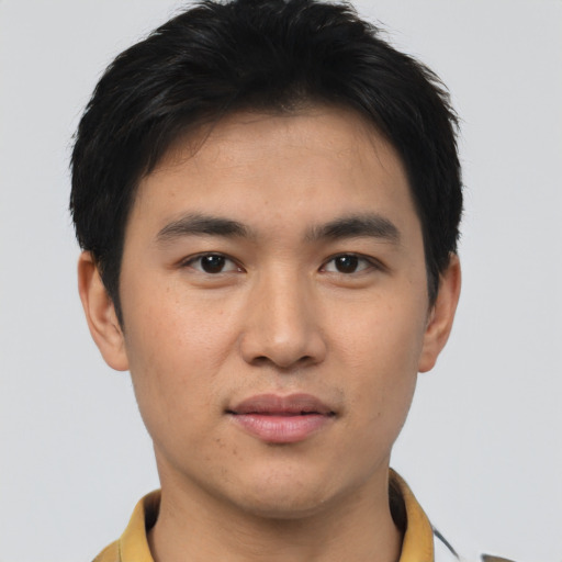 Joyful asian young-adult male with short  brown hair and brown eyes