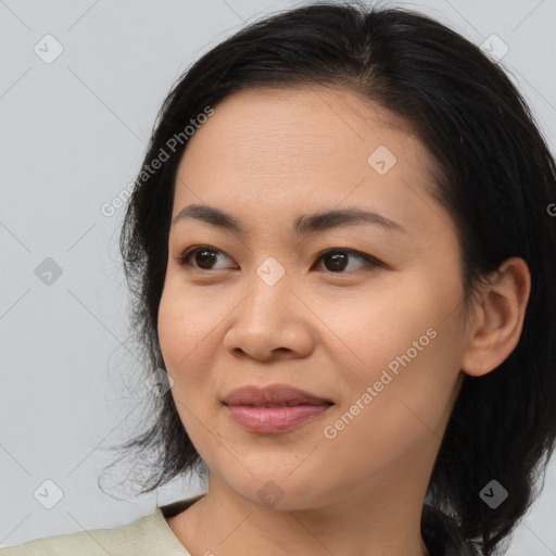 Joyful asian young-adult female with medium  black hair and brown eyes