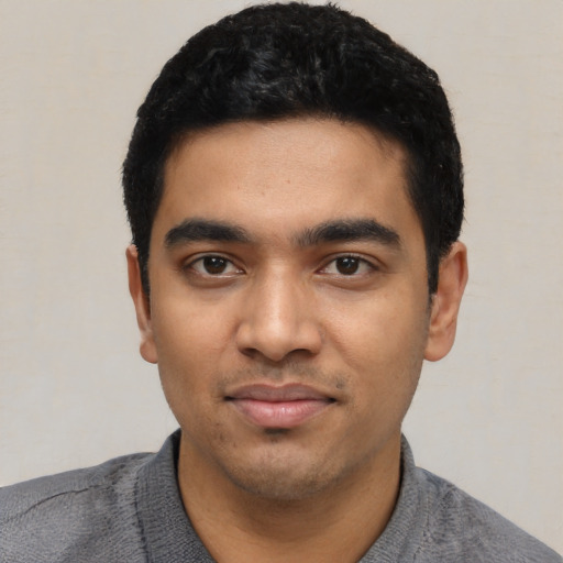 Joyful latino young-adult male with short  black hair and brown eyes