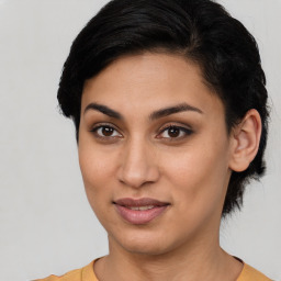 Joyful latino young-adult female with short  brown hair and brown eyes